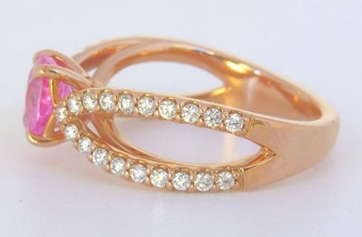 Shimmering pink sapphire ring with diamonds in rose gold, exuding joy and femininity.
